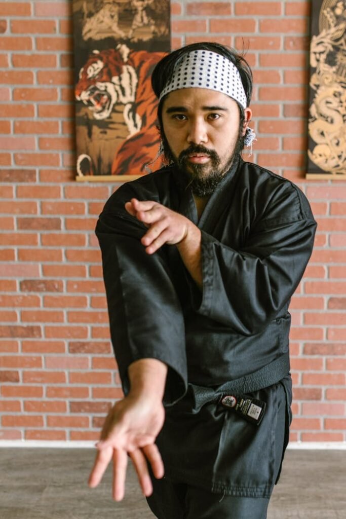A Man in Black Robe Doing Karate